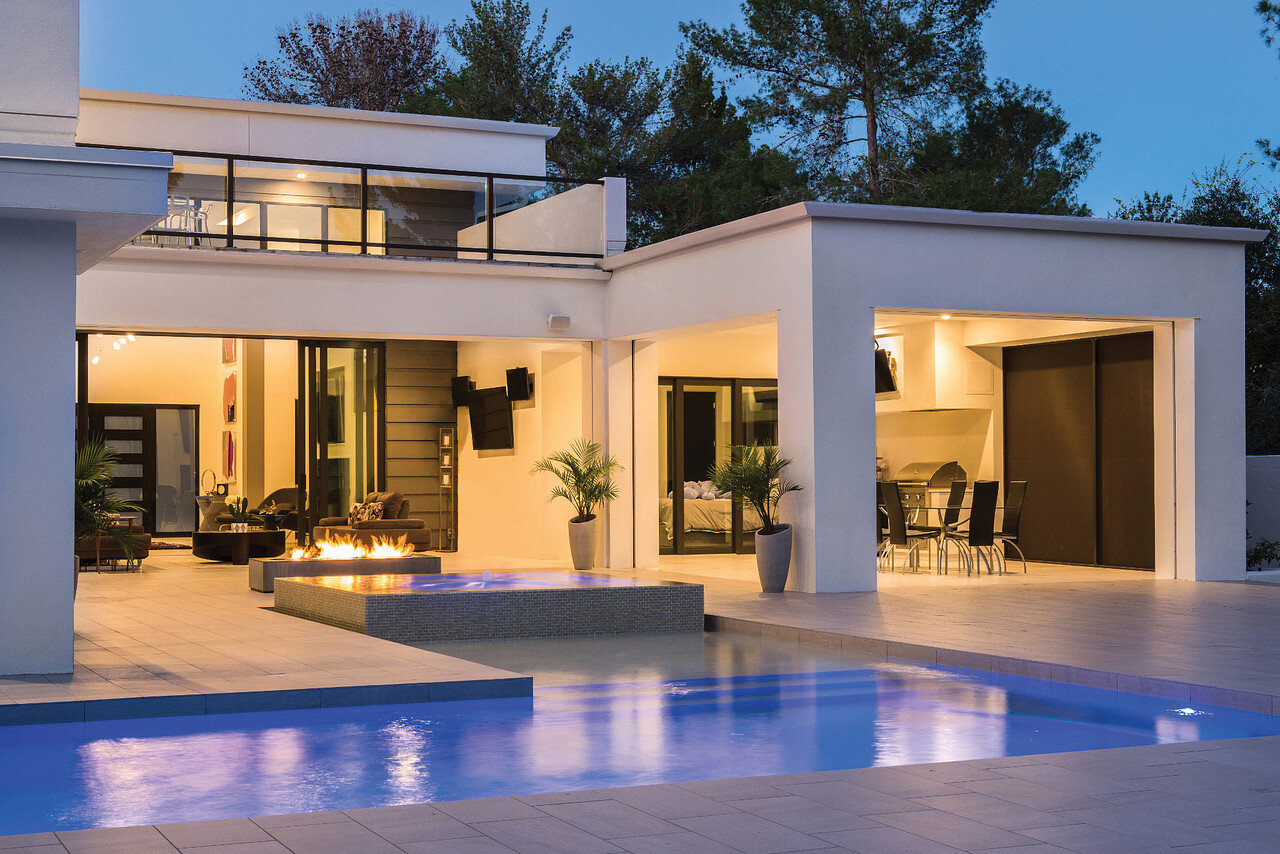 Outdoor pool area at dusk on a Lutron HomeWorks QSX multi-building lighting system