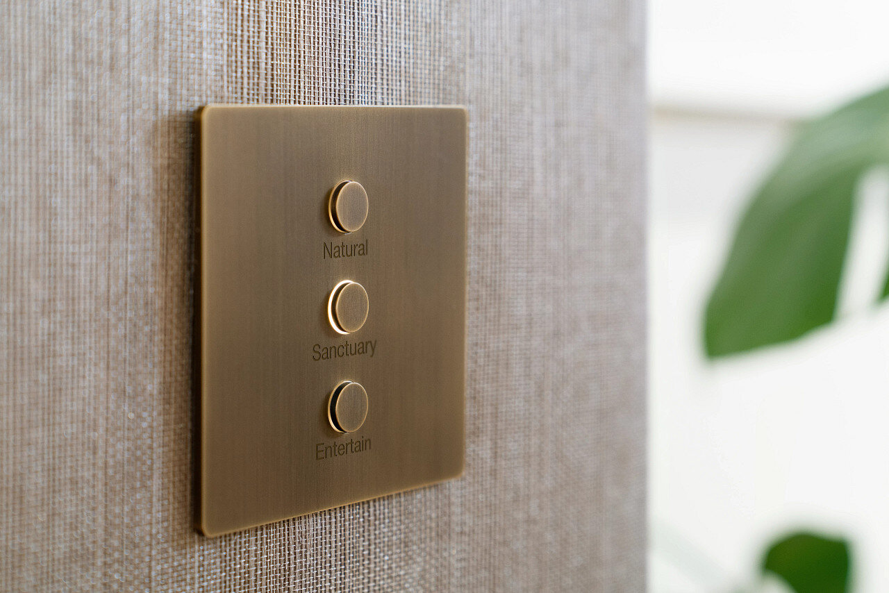 Lutron Alisse engraved keypad against patterned woven wallpaper