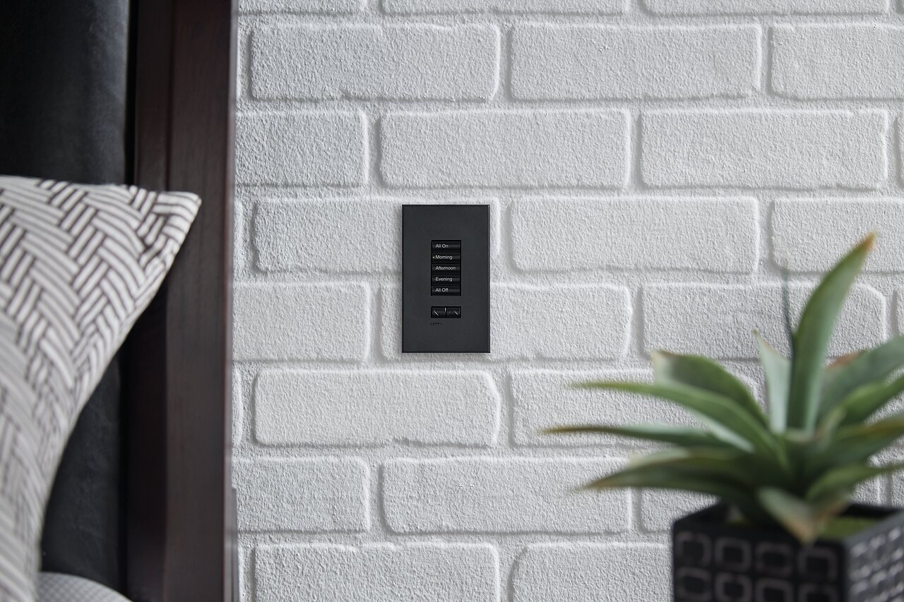 Lutron seeTouch 5-button keypad in pewter on a bedside wall