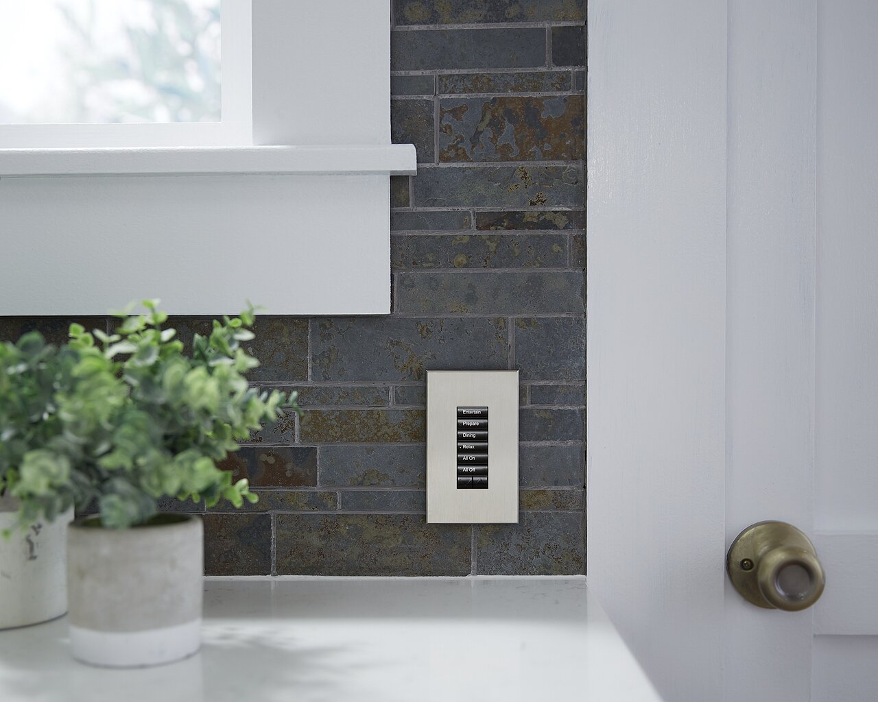 Lutron seeTouch 6-button keypad in satin nickel mounted in a custom kitchen