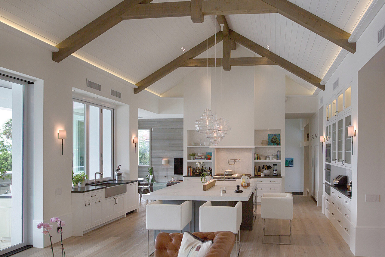 Same custom kitchen at 9 PM — warm dim evening scene on the same Lutron keypad