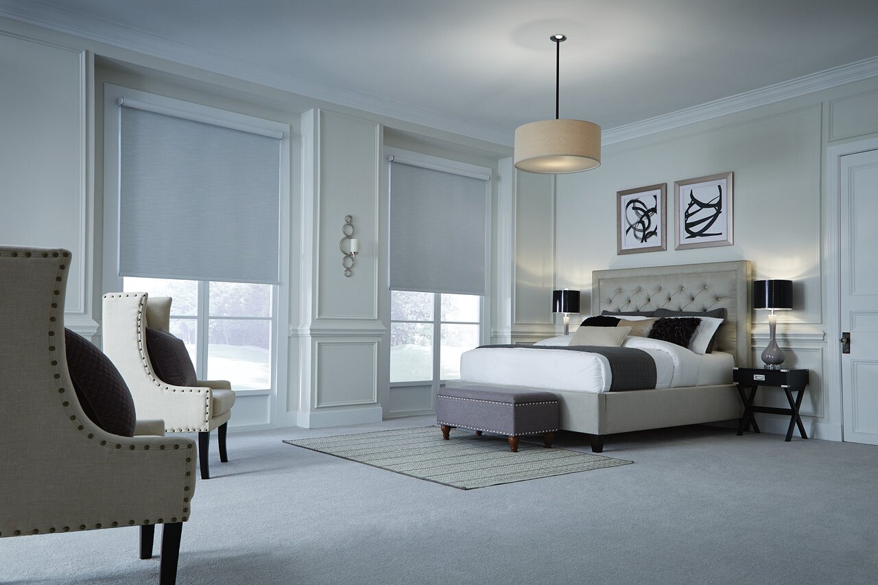 Motorized Lutron Palladiom drapery in a bedroom, opening to soft daylight