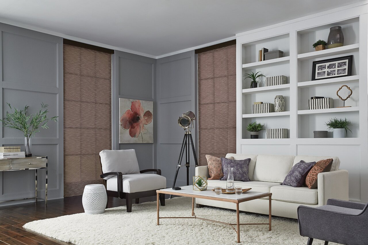 Living room with Lutron Sivoia QS roller shades lowered to soften afternoon light