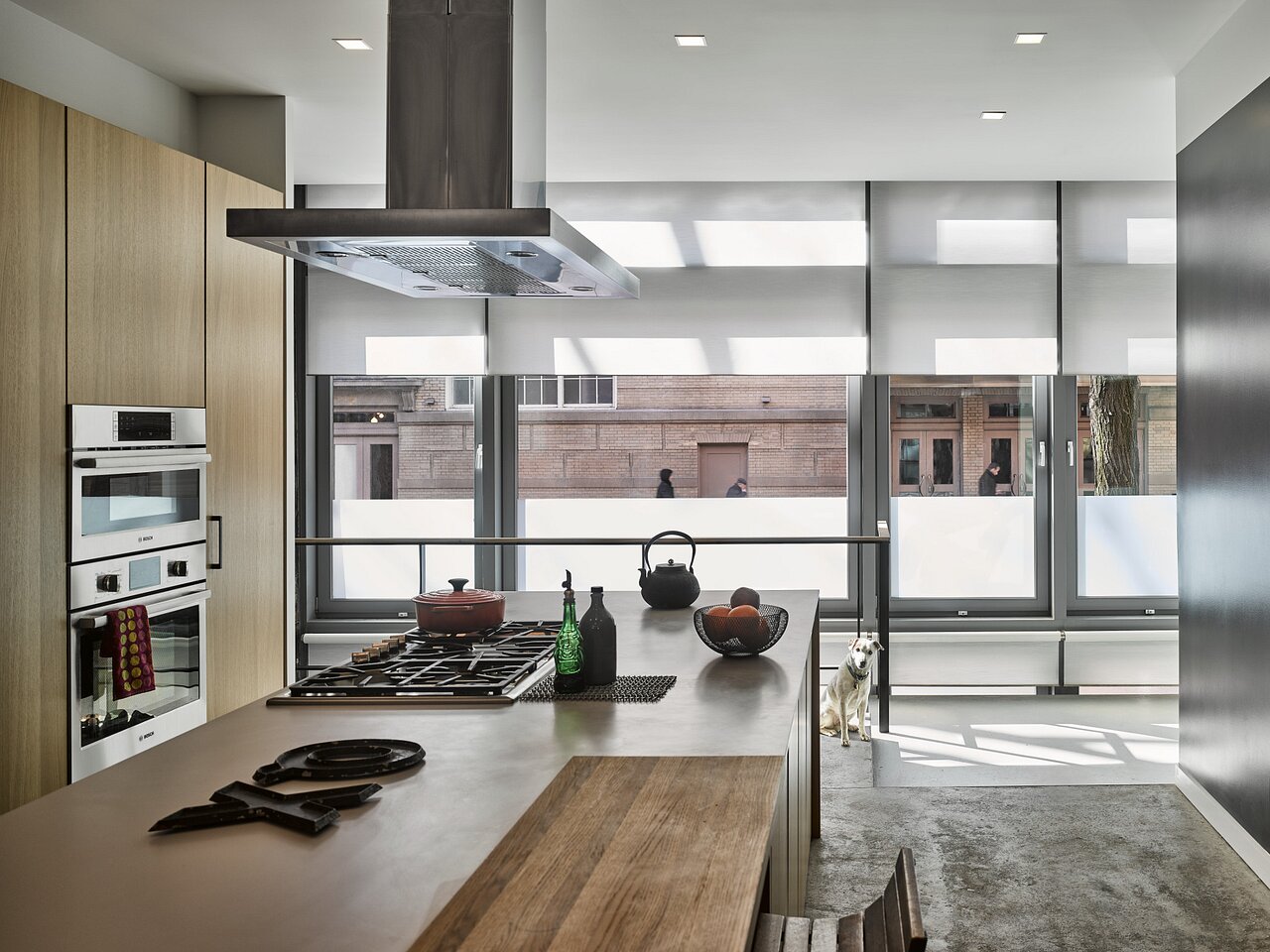 Modern kitchen with Lutron shades raised to a preset height, keeping the daytime view