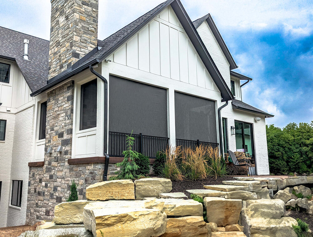 SunPro recessed exterior screens integrated into a luxury home's covered porch