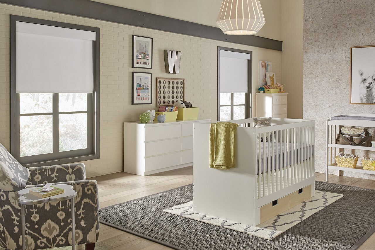Nursery with battery-powered Lutron Triathlon blackout shades partially lowered